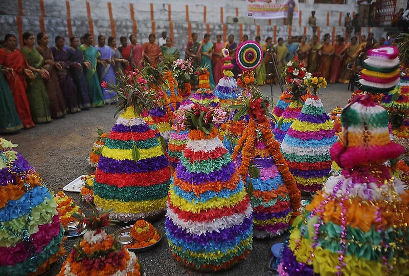 Hindu women dance around Bathukammas, floral arrangement representing the giver of life, during the Bathukamma festival dedicated to the Hindu goddess Gauri, in Hyderabad, India, Tuesday, Oct. 4, 2011. (AP Photo/Mahesh Kumar A.)